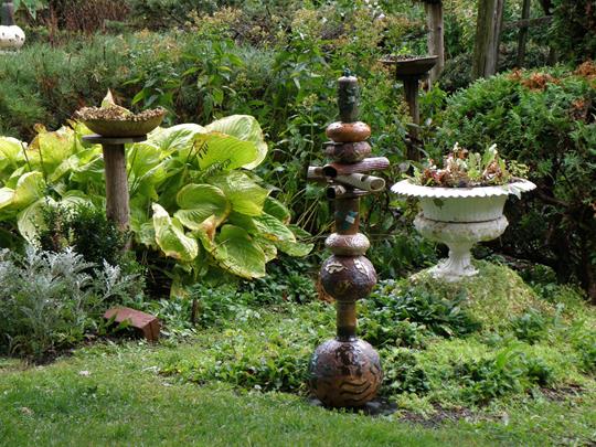 Ceramic sculptures by Naomi DeMuth in her own garden