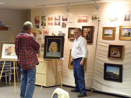 Wayne Daniels with his paintings