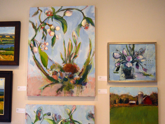 A wall full of vibrant paintings by Sally Hootnick