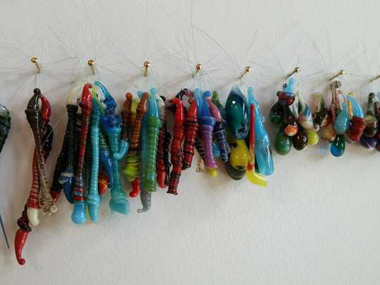A rainbow collection of student glass lampwork pendants at Caz College Jephson campus