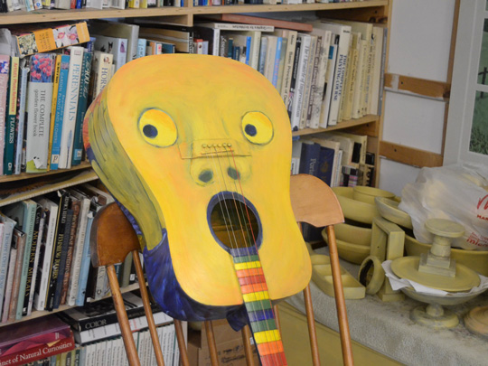 A wild, whimsical painted guitar by Marilyn Fegan