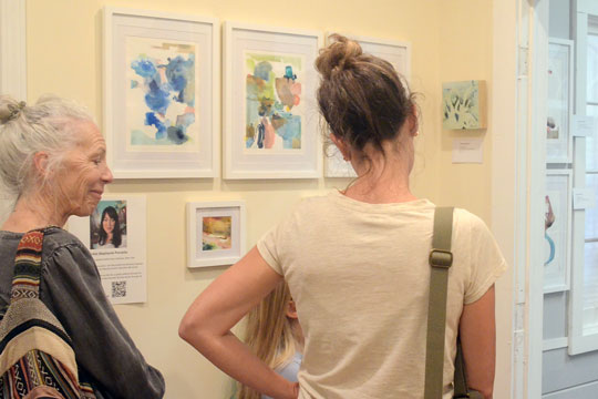 Art Trail hikers admiring works by Stephanie Porcello