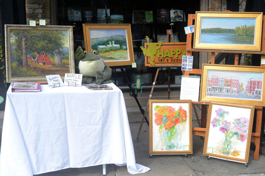 Jennifer Hooley is "Frog Happy" in front of 20|East.