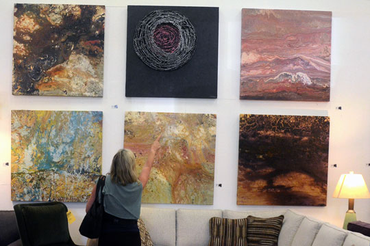 An Art Trail hiker admiring Shawn Gilmore's imposing pieces